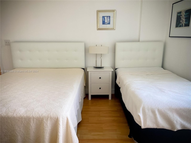 bedroom with hardwood / wood-style floors