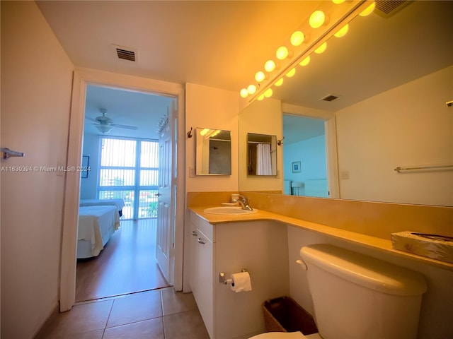 bathroom featuring vanity, toilet, ceiling fan, and tile patterned floors