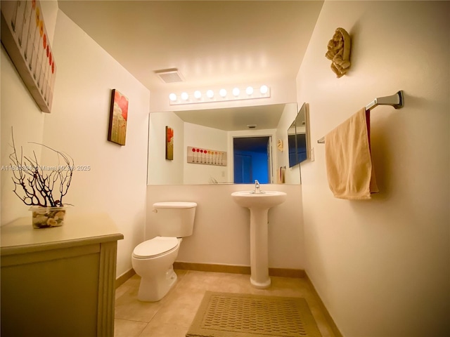 bathroom with toilet, baseboards, visible vents, and tile patterned flooring