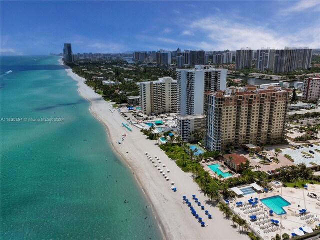 bird's eye view featuring a water view and a beach view