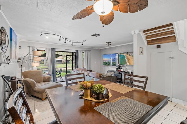 tiled living room with a textured ceiling, beam ceiling, and ceiling fan