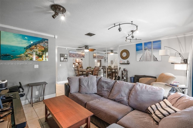 living room featuring a textured ceiling, light tile patterned flooring, and crown molding