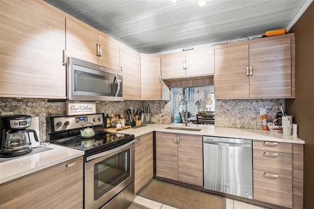 kitchen featuring sink, stainless steel appliances, and backsplash