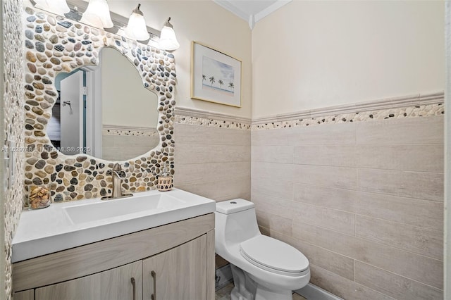 bathroom featuring tile walls, vanity, and toilet