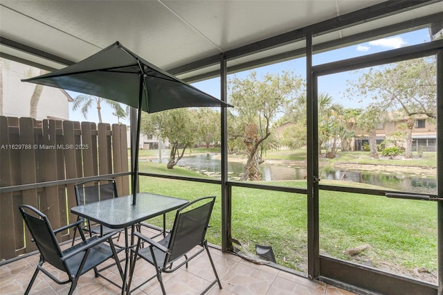 unfurnished sunroom featuring a water view