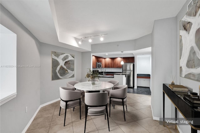 dining space with sink and light tile patterned flooring