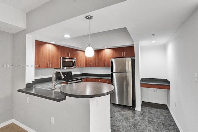 kitchen featuring decorative light fixtures, sink, kitchen peninsula, and appliances with stainless steel finishes