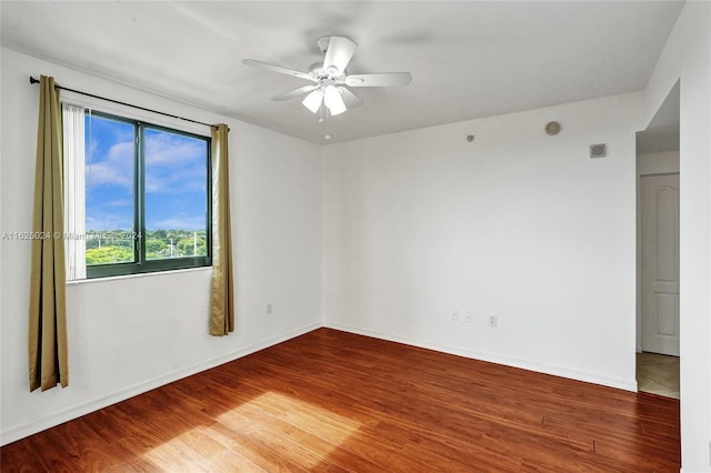 spare room featuring ceiling fan and hardwood / wood-style floors