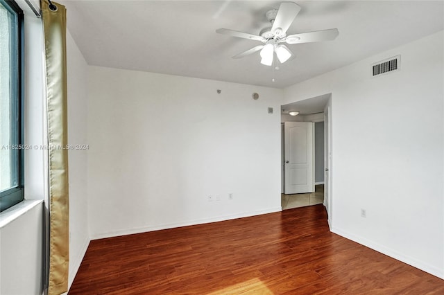 empty room with hardwood / wood-style flooring and ceiling fan