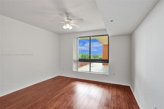 spare room with hardwood / wood-style flooring and ceiling fan