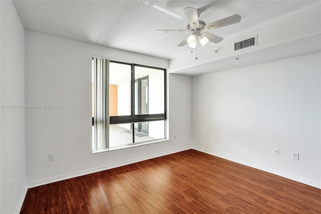 spare room featuring a textured ceiling, plenty of natural light, hardwood / wood-style flooring, and ceiling fan