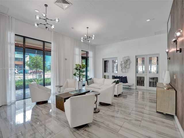 living room featuring french doors and a chandelier