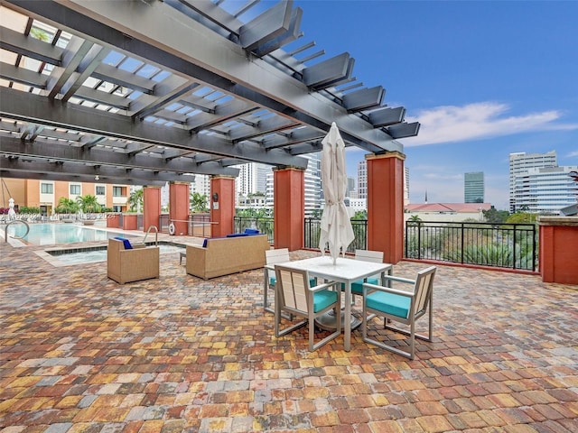 view of patio featuring a community pool and a pergola