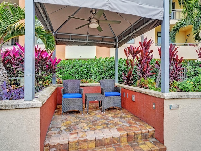 view of patio featuring ceiling fan and a gazebo