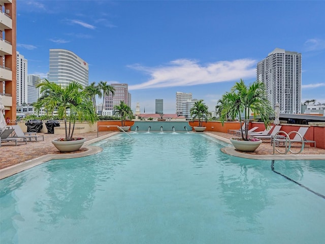 view of swimming pool with pool water feature