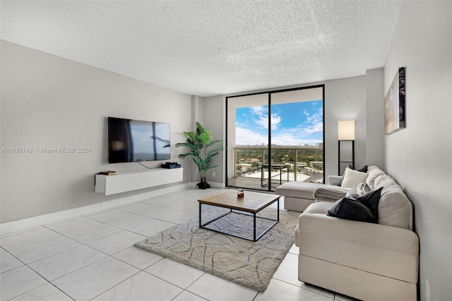 tiled living room featuring floor to ceiling windows and a textured ceiling