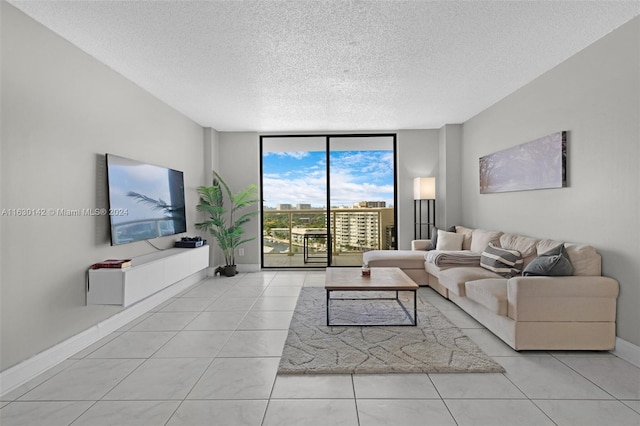 tiled living room with floor to ceiling windows and a textured ceiling