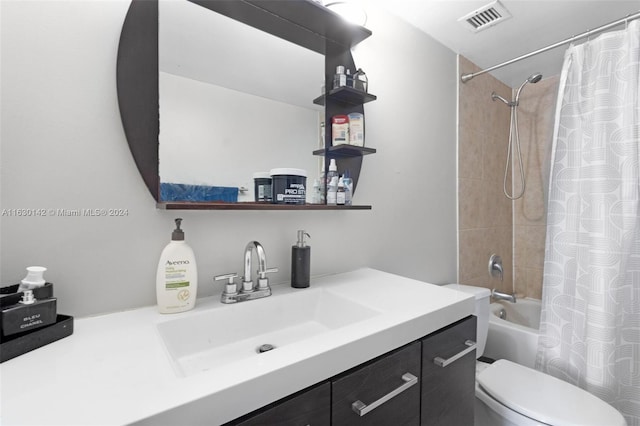 full bathroom with vanity, shower / bath combo, and toilet