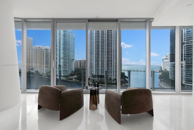 interior space featuring a water view and expansive windows