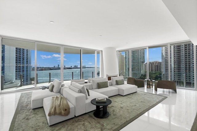 living room with a water view and a wall of windows