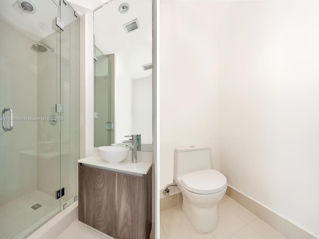 bathroom with vanity, walk in shower, tile patterned floors, and toilet