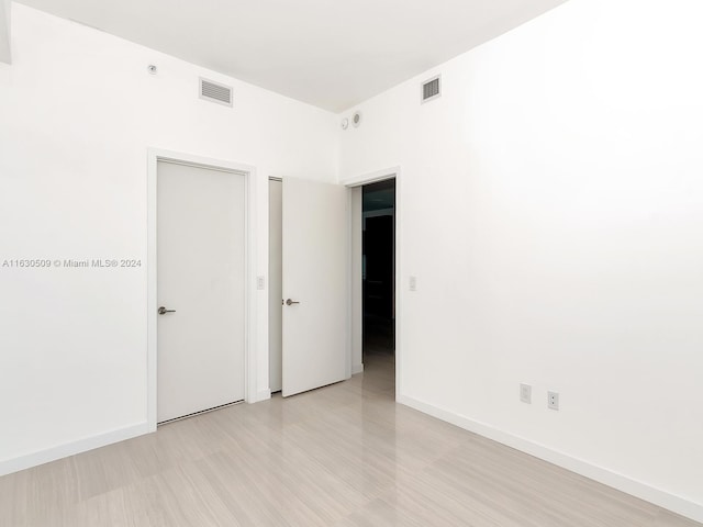 spare room featuring light hardwood / wood-style floors