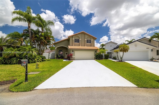 view of front of house featuring a front yard and a garage