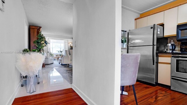 dining space with a drop ceiling and dark wood-type flooring