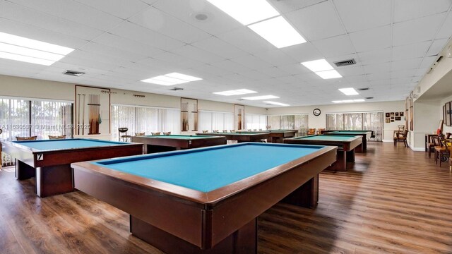 game room featuring dark hardwood / wood-style flooring, a drop ceiling, and billiards