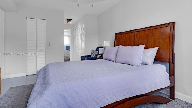 bedroom with ceiling fan and tile patterned flooring