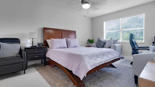 bedroom with ceiling fan and a textured ceiling