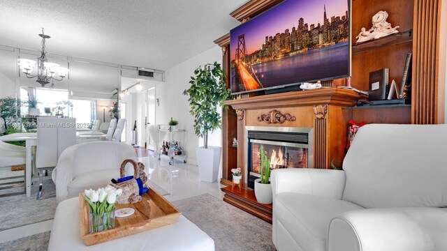 living room featuring a notable chandelier, light tile patterned floors, and a textured ceiling