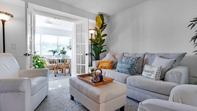 carpeted living room featuring a textured ceiling