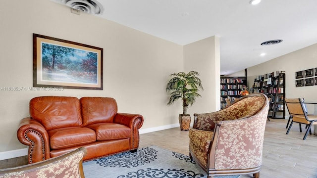 living room featuring lofted ceiling and light wood-type flooring