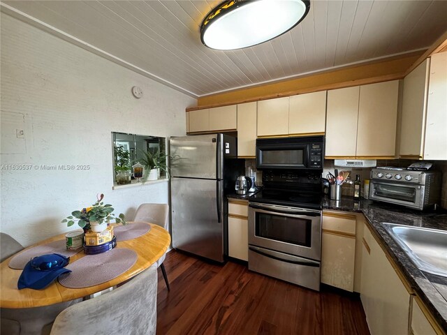 kitchen featuring cream cabinets, appliances with stainless steel finishes, tasteful backsplash, dark hardwood / wood-style flooring, and wood ceiling