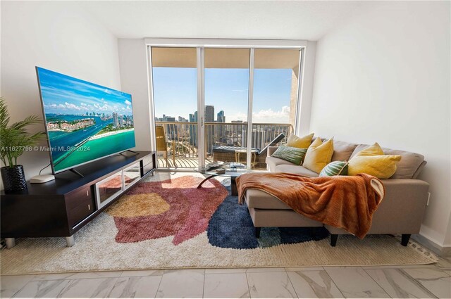 living room featuring tile patterned flooring and floor to ceiling windows