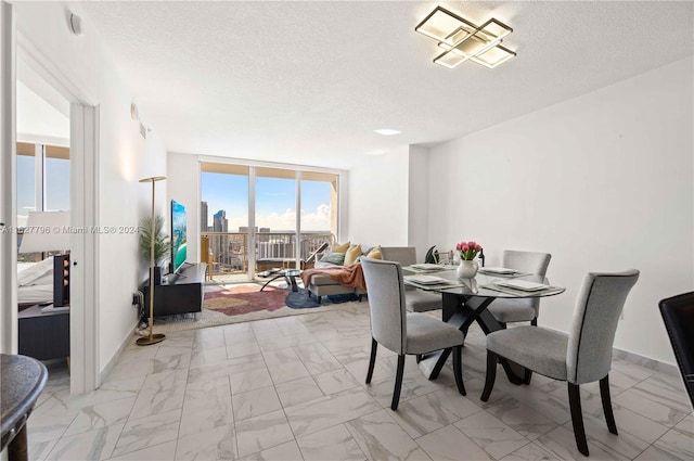 dining room with a textured ceiling and floor to ceiling windows