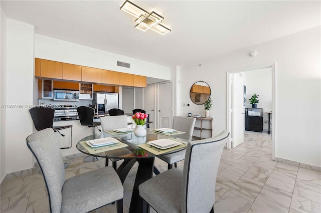 dining space with light tile patterned floors