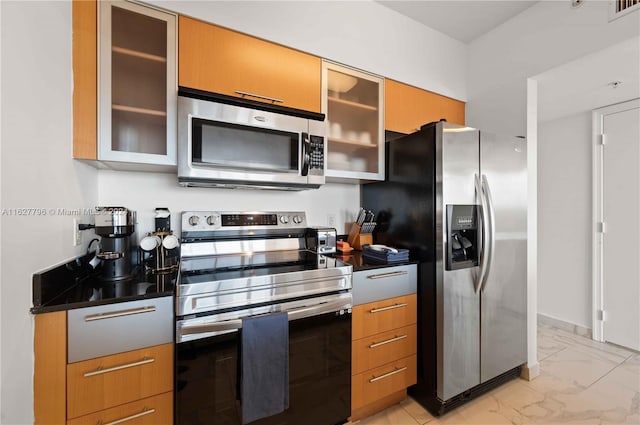 kitchen featuring stainless steel appliances and light tile patterned floors