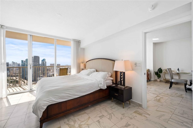 bedroom with light tile patterned floors, access to exterior, and floor to ceiling windows