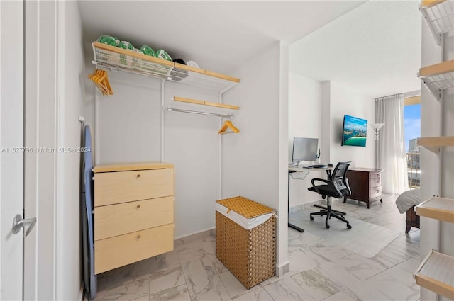 spacious closet with light tile patterned floors