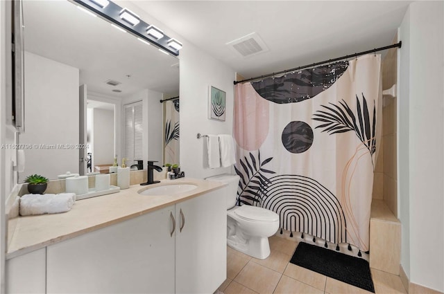 bathroom with tile patterned flooring, vanity, toilet, and walk in shower