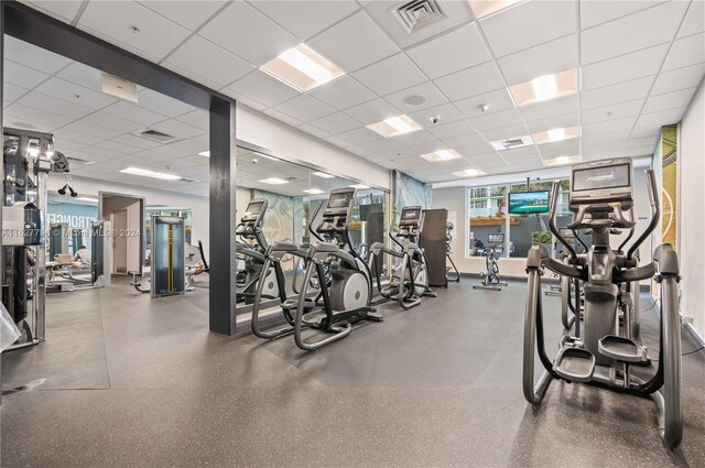 exercise room with a paneled ceiling