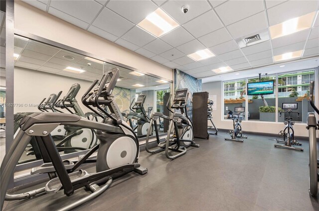 workout area featuring a paneled ceiling