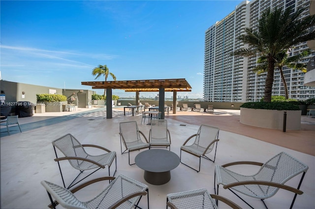 view of community with a patio and a pergola