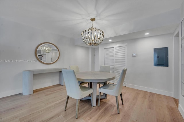 dining area with expansive windows, light wood-type flooring, and a chandelier