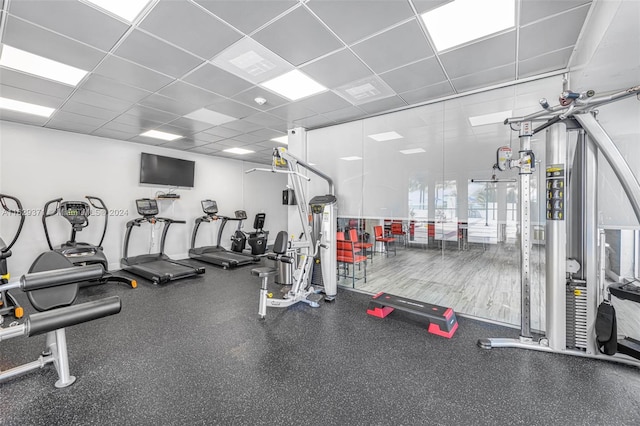 exercise room with a paneled ceiling