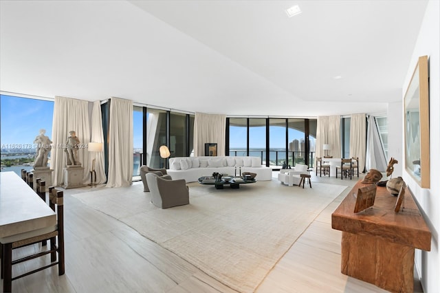 living room with light wood-type flooring and a wall of windows