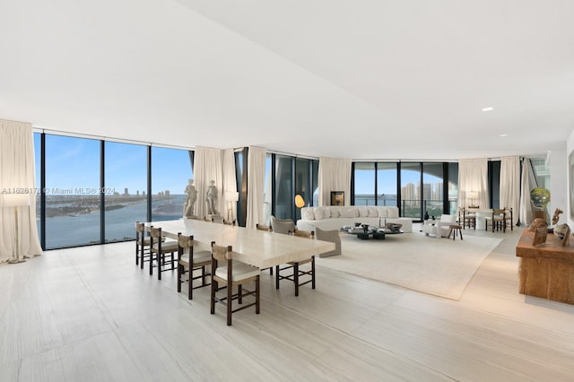 dining area featuring a water view and floor to ceiling windows