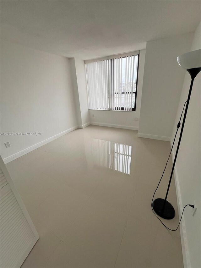 spare room featuring tile patterned flooring